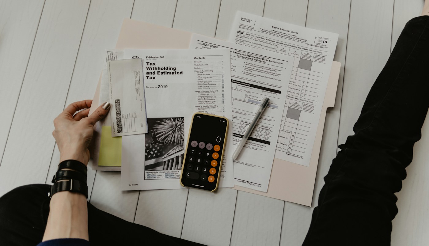 Reviewing financial paperwork with a calculator